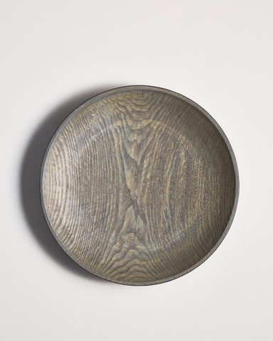 Round wooden bowl by Ryuji mitani on a light gray background