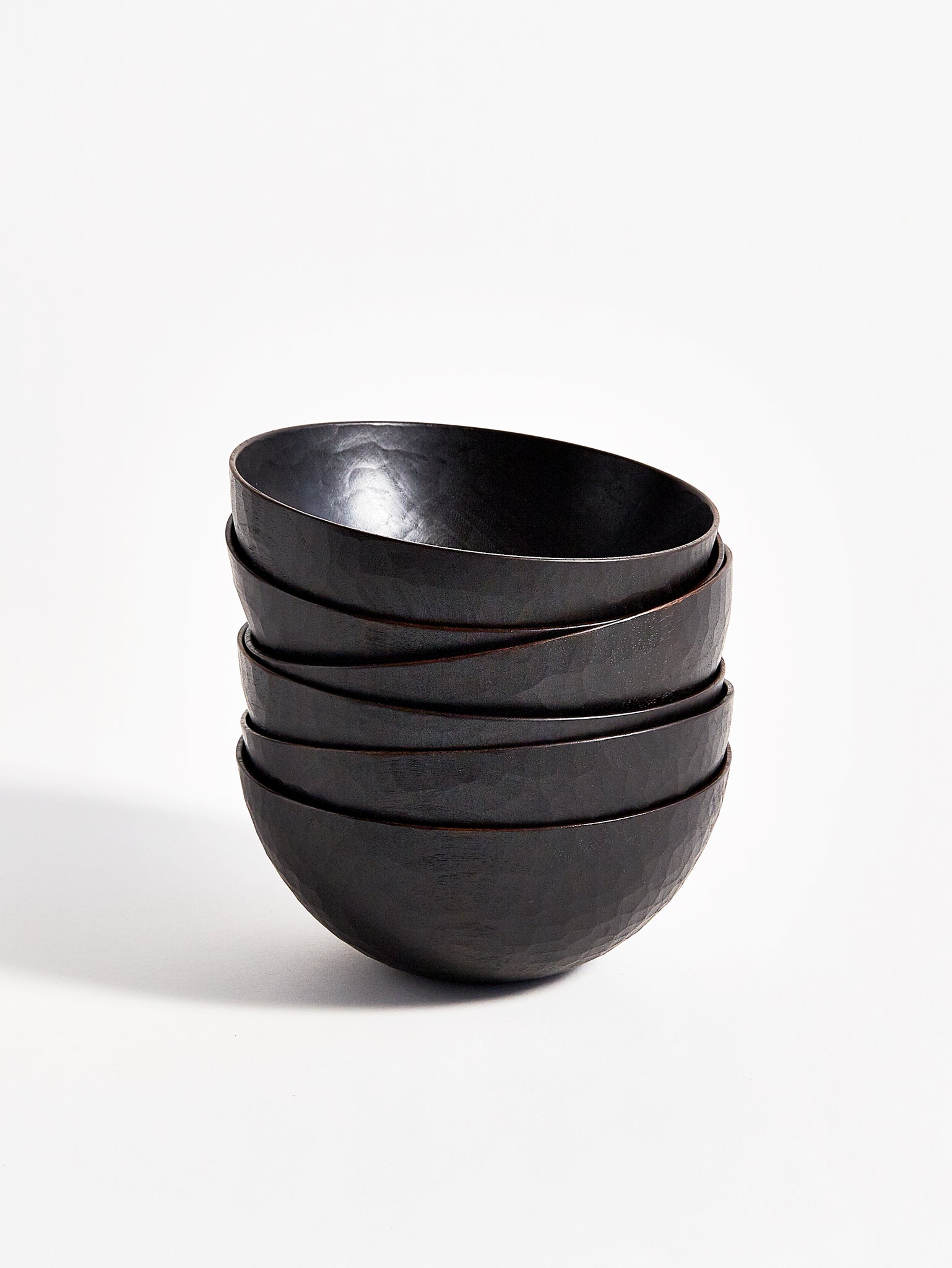 Front view of 6 stacked Usuzumi Black Walnut Bowls by Ryuji Mitani against white-gray background.