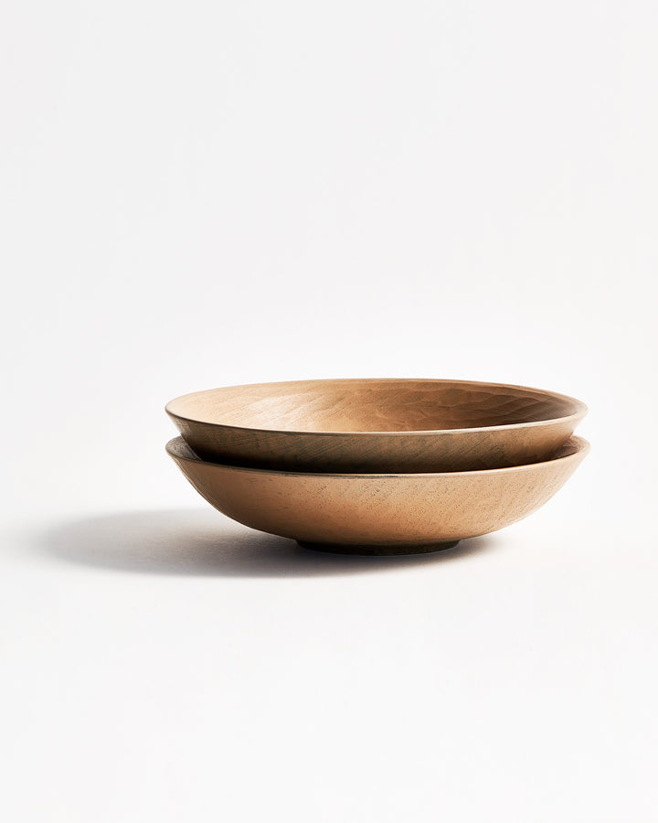 Front view of 2 stacked White Urushi Confectionary Platters by Ryuji Mitani against white-gray background.