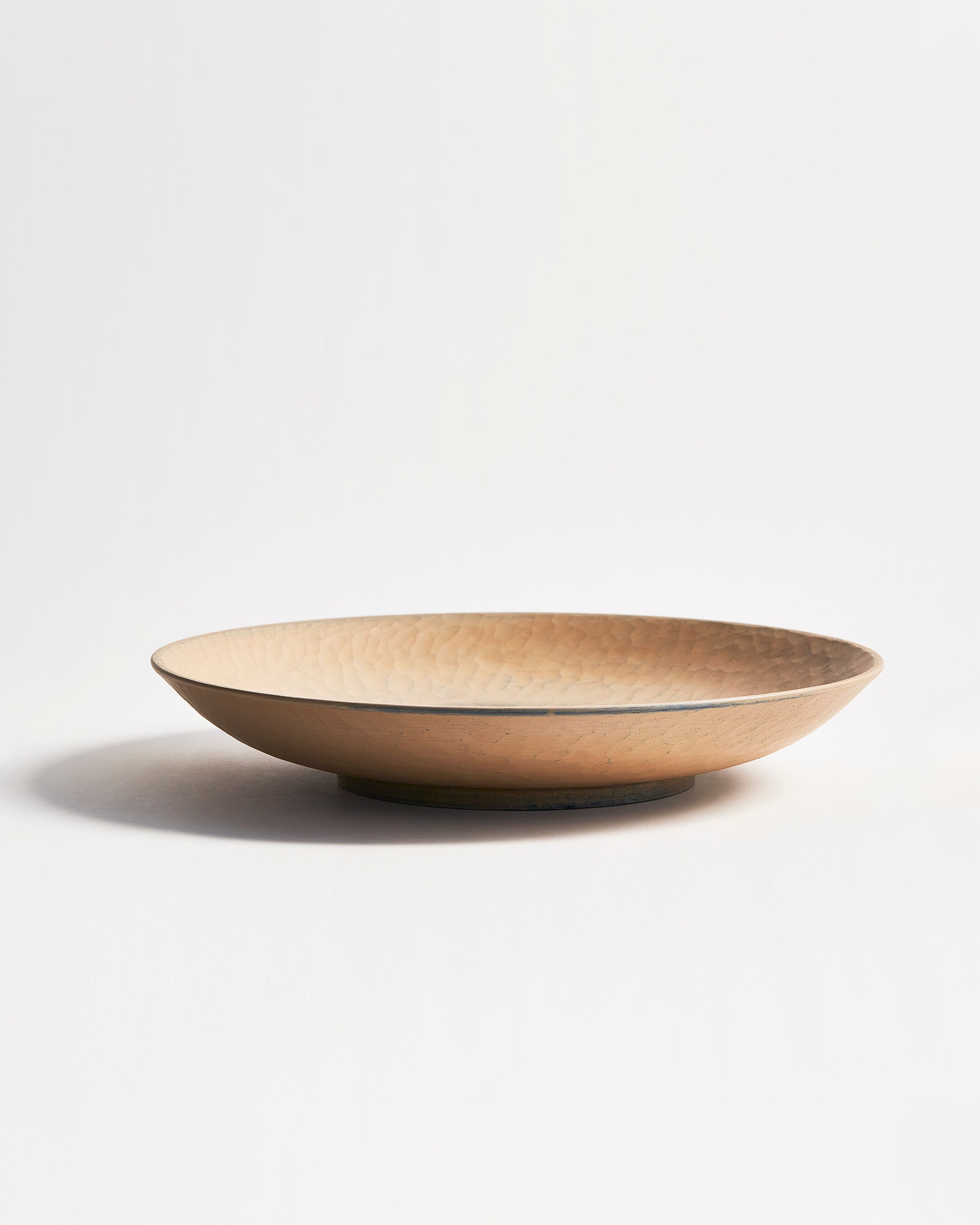 Full side view of beige wooden bowl by Ryuji Mitani on a gray background