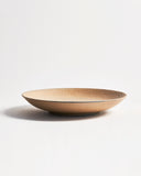 Full side view of beige wooden bowl by Ryuji Mitani on a gray background