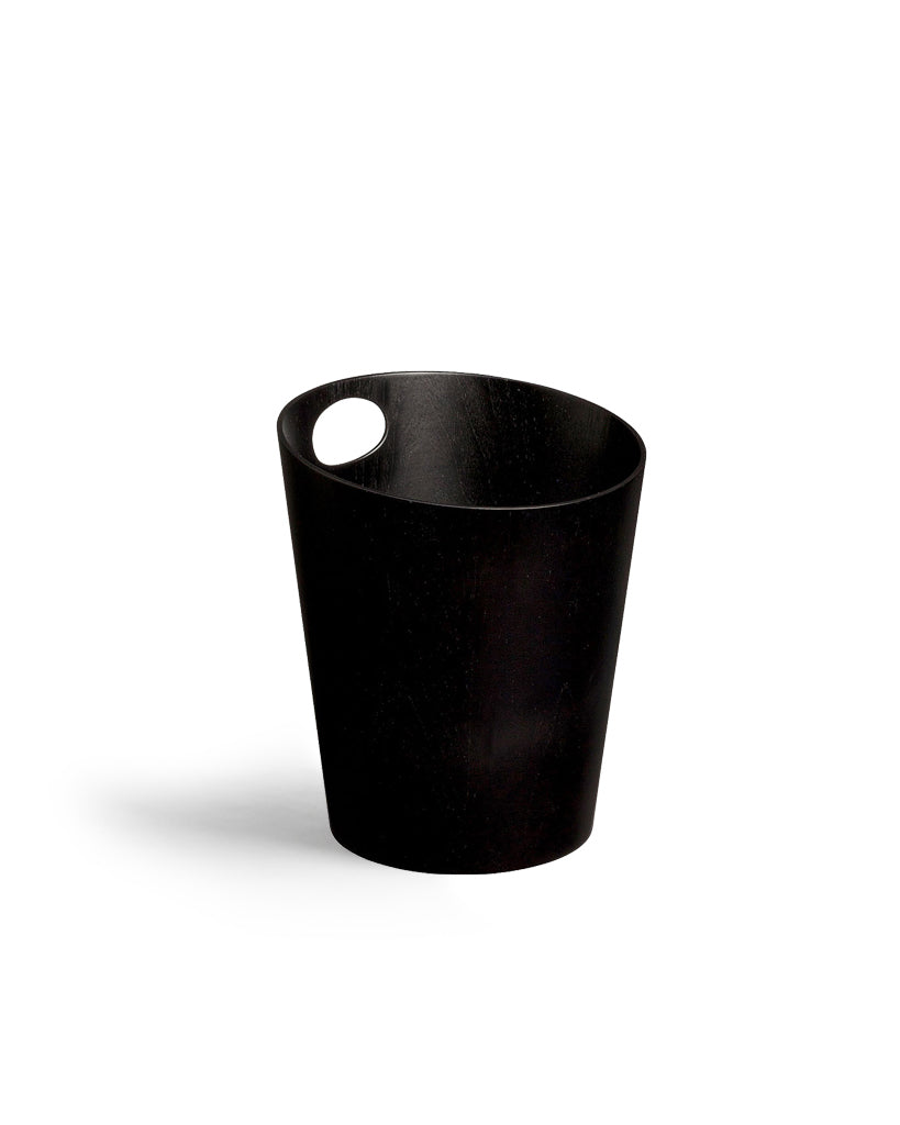 Silhouetted image of black ash paper waste basket by Isamu Saito against white background.