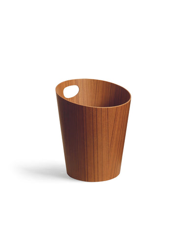 Silhouetted image of teak paper waste basket with handle by Isamu Saito against white background.
