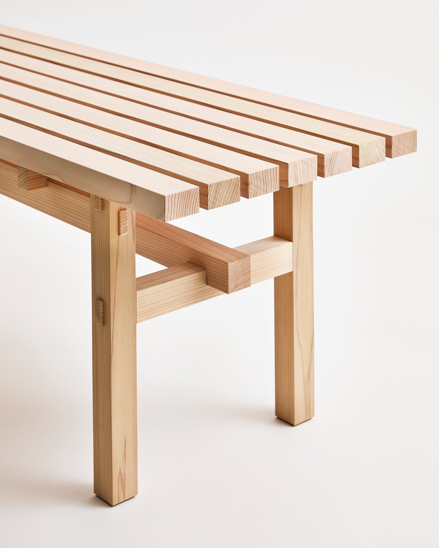 Up-close of Cedar Wood Bench by Time and Style on a Gray background