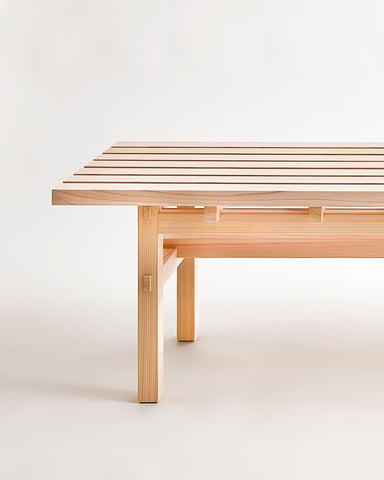 Up-close of Cedar Wood Bench by Time and Style on a gray background