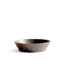 A brown textured bowl against white background.