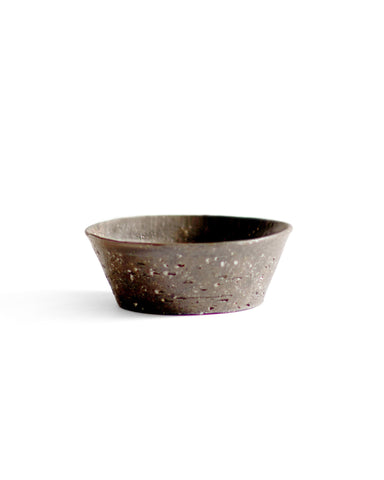 A brown textured bowl against white background.