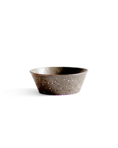 A brown textured bowl against white background.