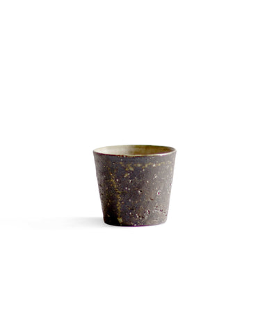 A brown textured cup against white background.