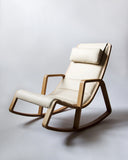 3/4 view of tonton rocking chair against gray background.