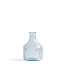 Silhouetted reclaimed blue carafe by factory zoomer against white background.