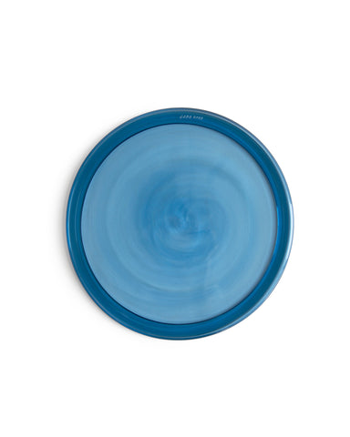 Top view of silhouetted reclaimed blue folded rim plate in blue. 