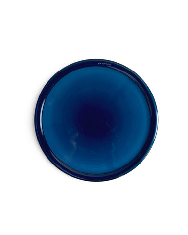 Top view of silhouetted reclaimed blue folded rim plate in dark blue. 