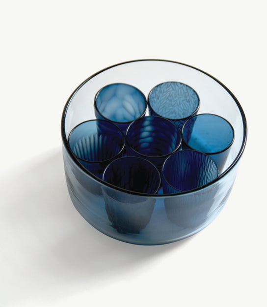 Top view of the reclaimed blue 'nature's diary' glass set. Details of unique carved patterns for each cups are visible.