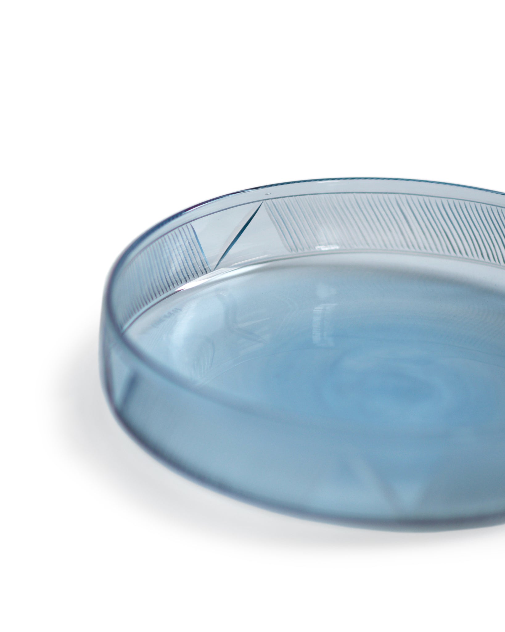 Cropped detail view of the light blue reclaimed blue schale focusing on the signature 'Factory Zoomer x Nalata Nalata' cut glass pattern.
