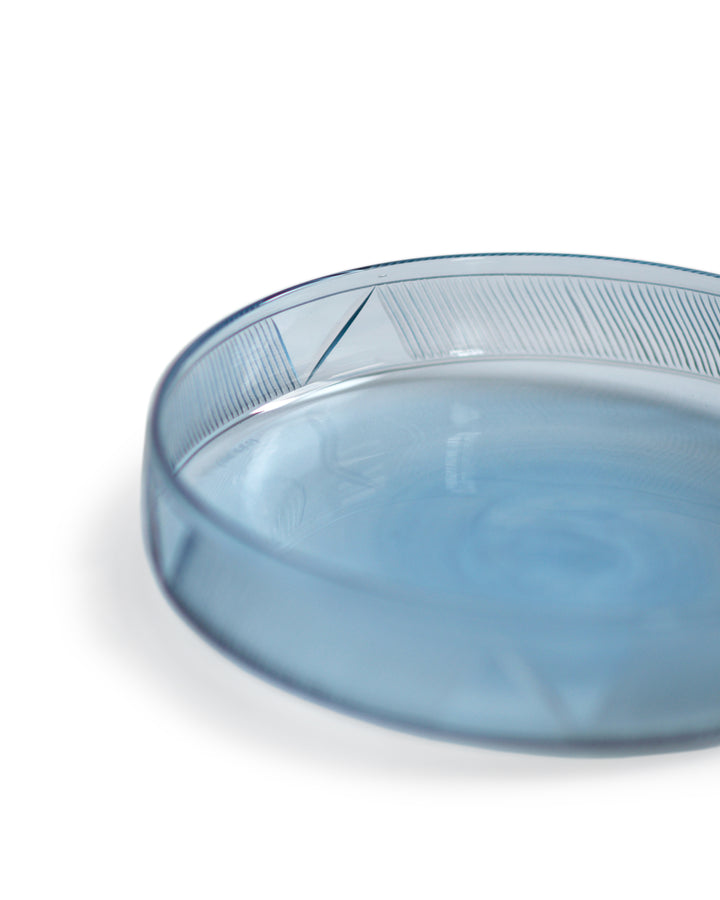 Cropped detail view of the light blue reclaimed blue schale focusing on the signature 'Factory Zoomer x Nalata Nalata' cut glass pattern.