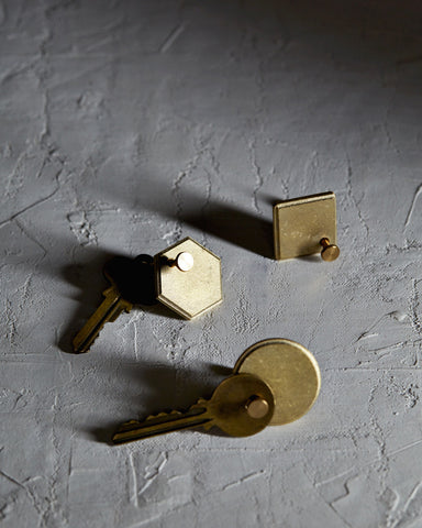 Diamond Plate, Circle Plate, and Hexagon Plate Key Rings by Futagami on a textured white surface