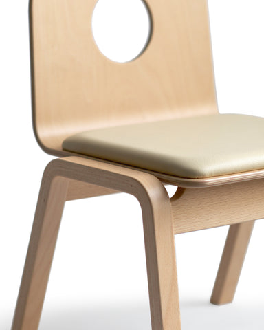 Detailed image of the hold children's chair focusing on the wood grains of the side leg.