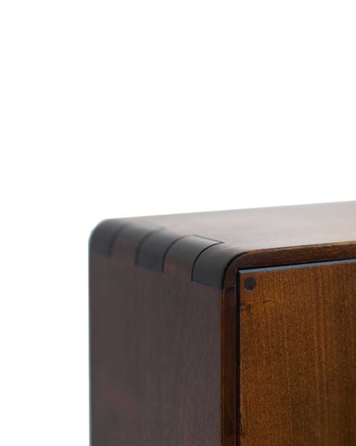 Detailed image of the wood joinery of the top corner of the tabletop glass vitrine.