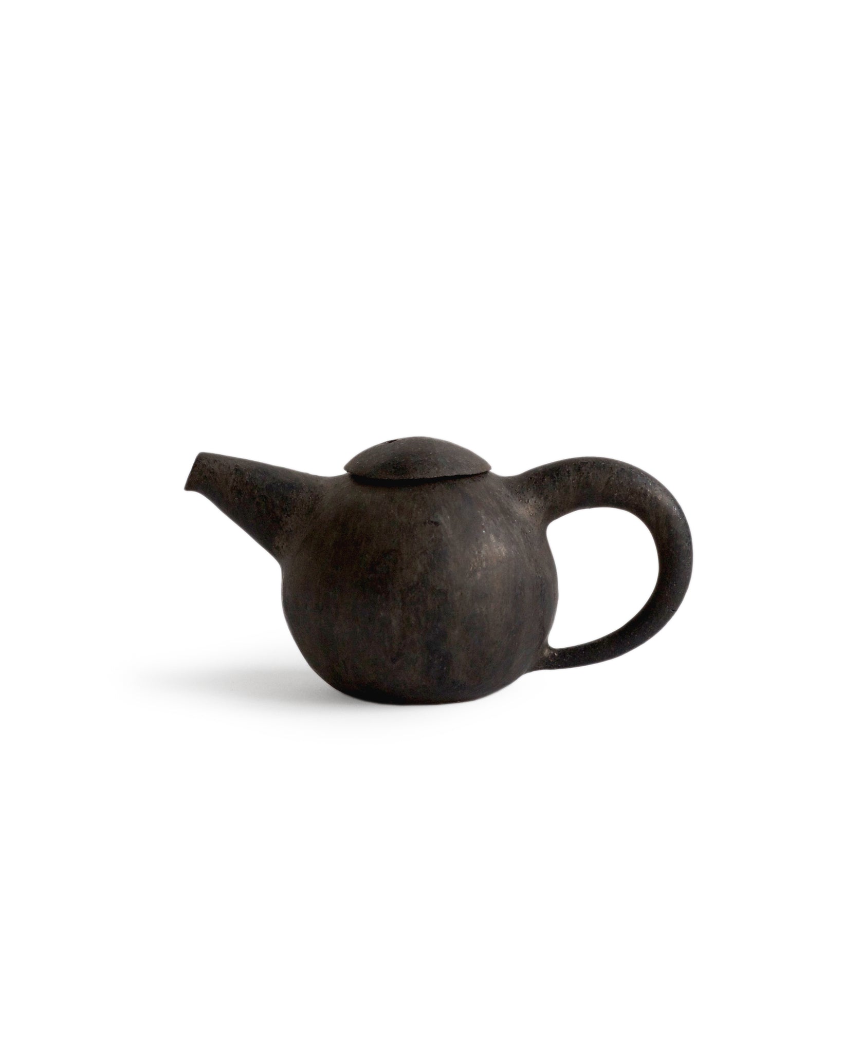 Black Teapot by Keisuke Iwata against white backdrop