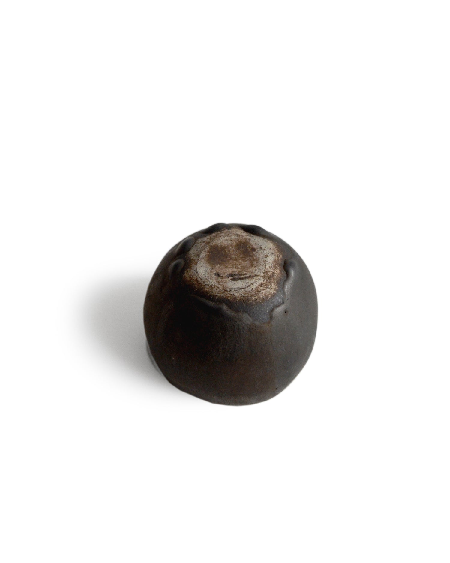 Round black ceramic pod cup handcrafted by Keisuke Iwata against white background