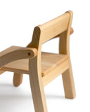 Detailed image of 1 year old school chair focusing on wood joinery on the armrest.