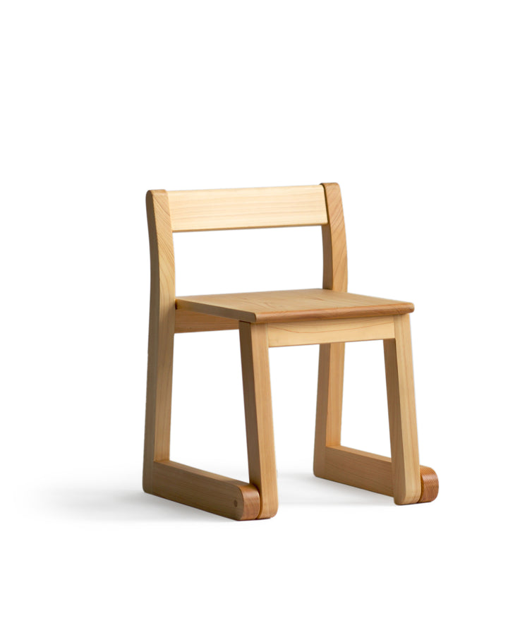 Silhouetted image of a 2 to 5 years old school chair against white background at an angle.