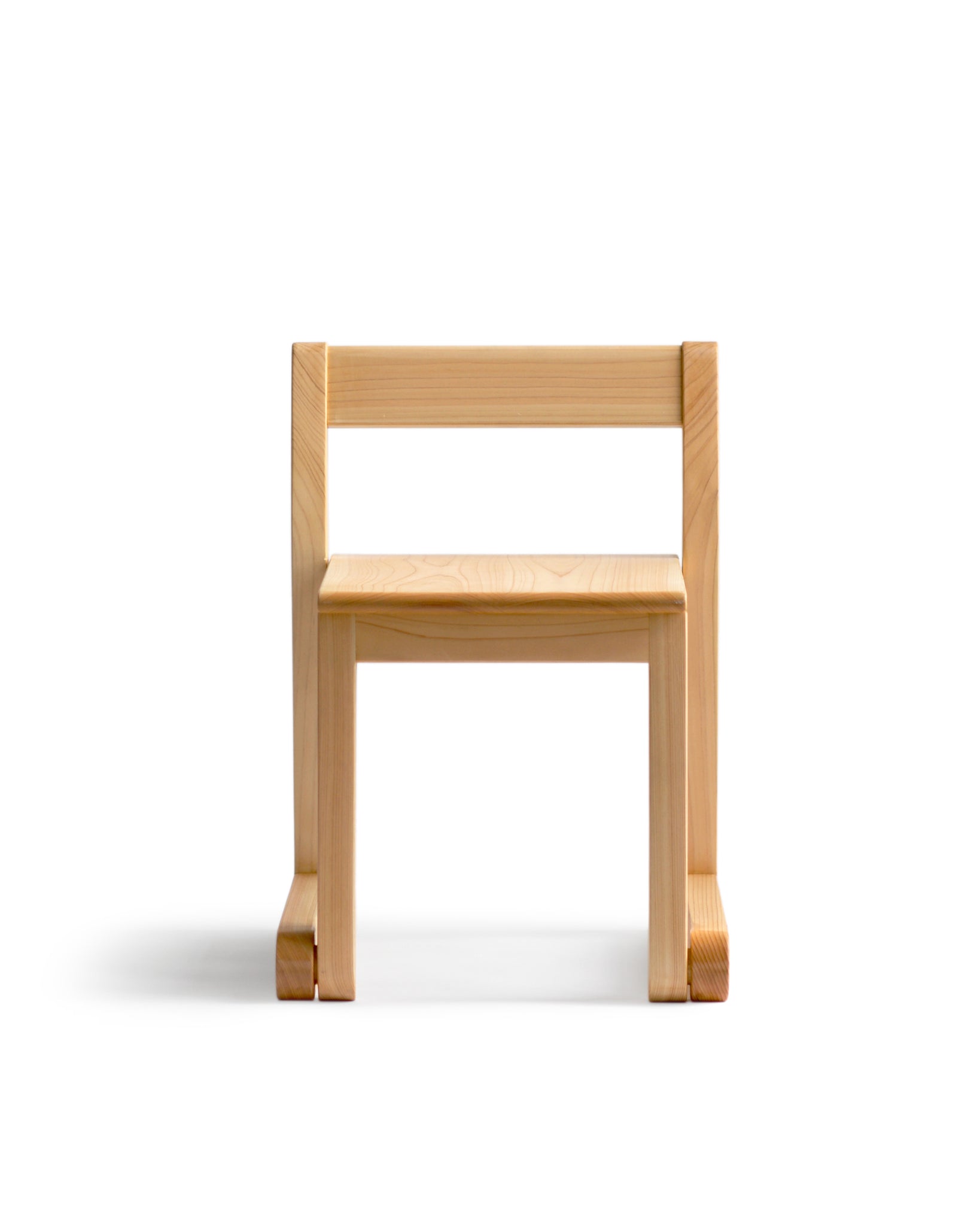 Silhouetted image of a 2 to 5 years old school chair against white background.