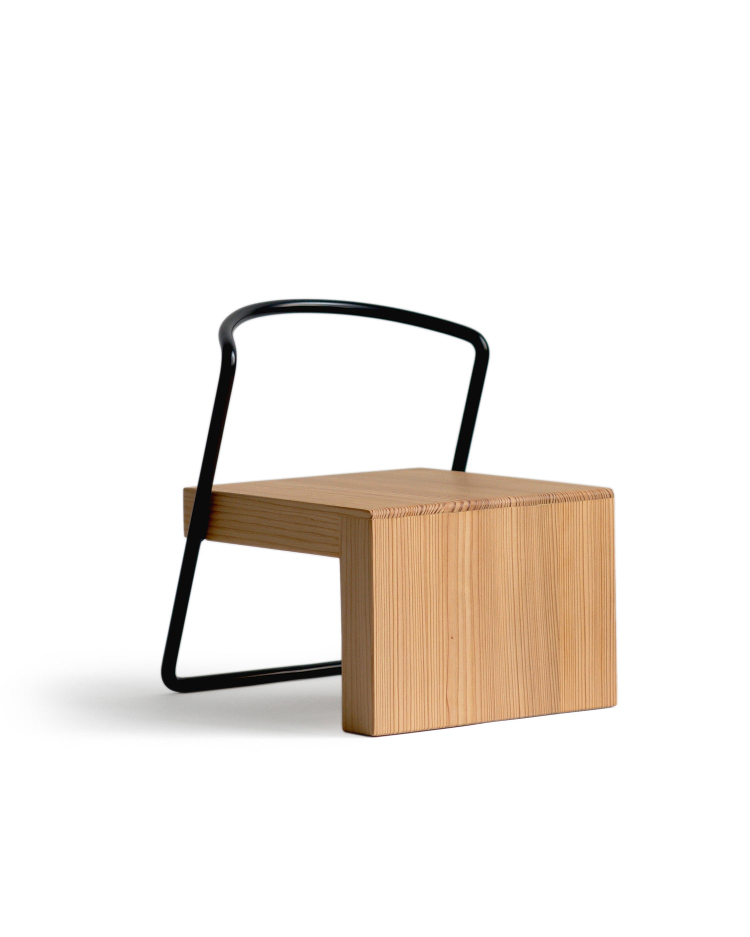 Silhouetted image of the Tetsubo Children's Chair against white background at an angle.