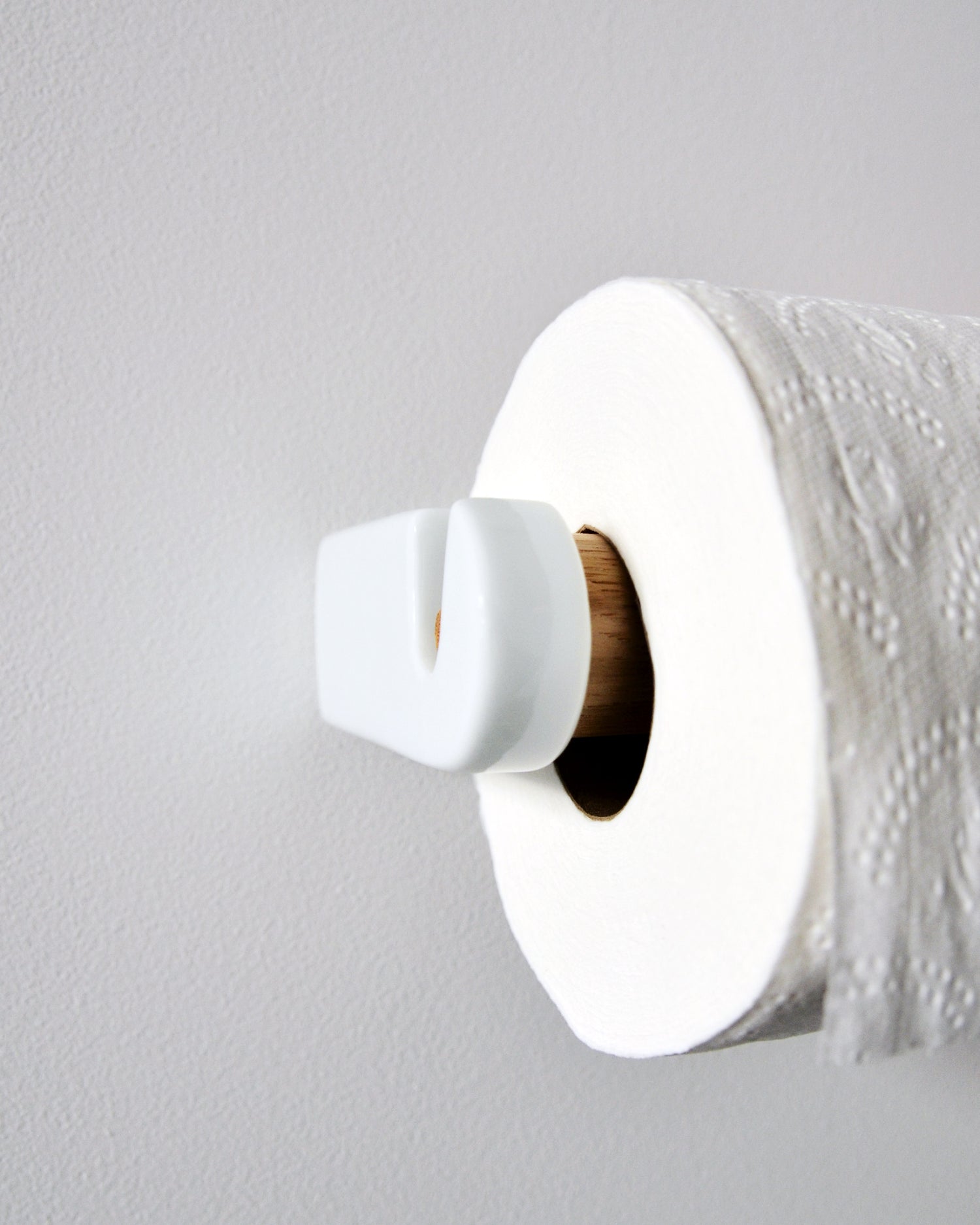 White porcelain and wood toilet paper roll holder by Makoto Koizumi