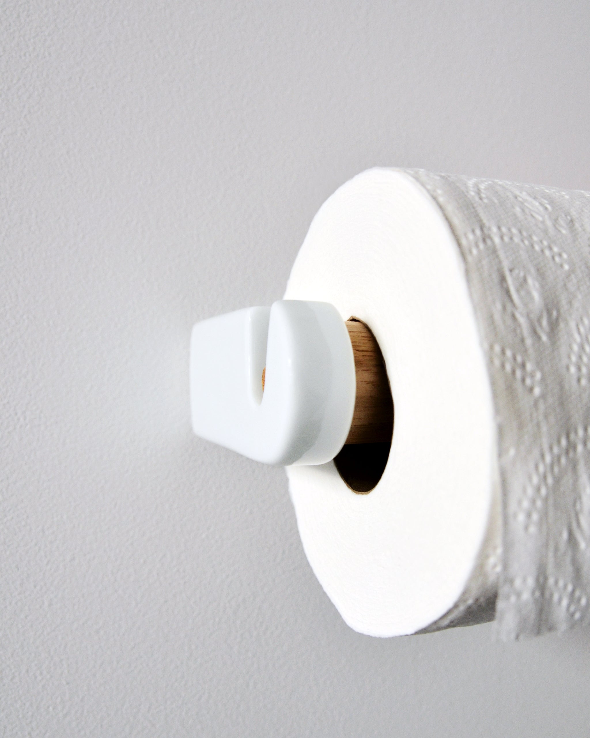 White porcelain and wood toilet paper roll holder by Makoto Koizumi