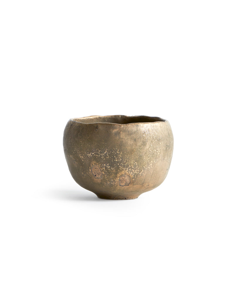Gold Chawan II silhouetted against white background.