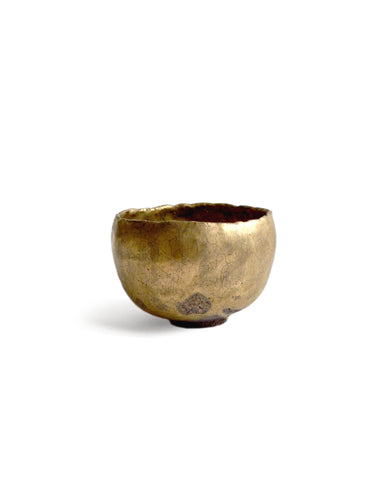 Gold Chawan III silhouetted against white background.
