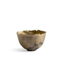 Gold Chawan IV silhouetted against white background.