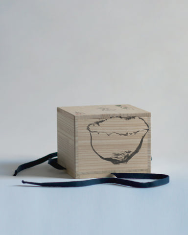 Wood box for Gold Chawan IV at an angle, with Masanobu Ando's drawing of the chawan showing. 