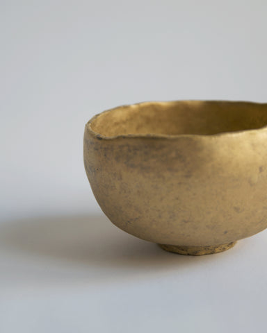 Detailed view of Gold Chawan IX against gray background.