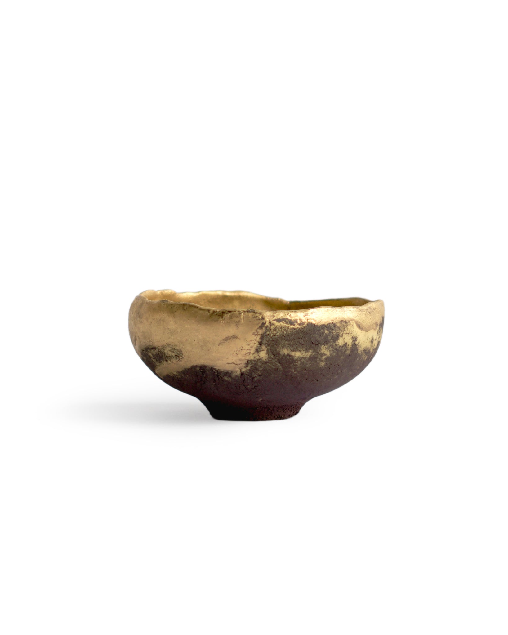 Gold Chawan VII silhouetted against white background.