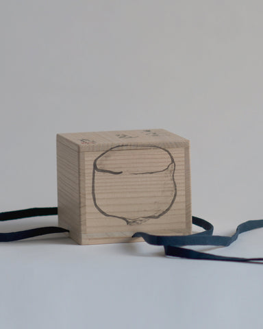 Wood box for Gold Chawan V at an angle, with Masanobu Ando's drawing of the chawan showing.