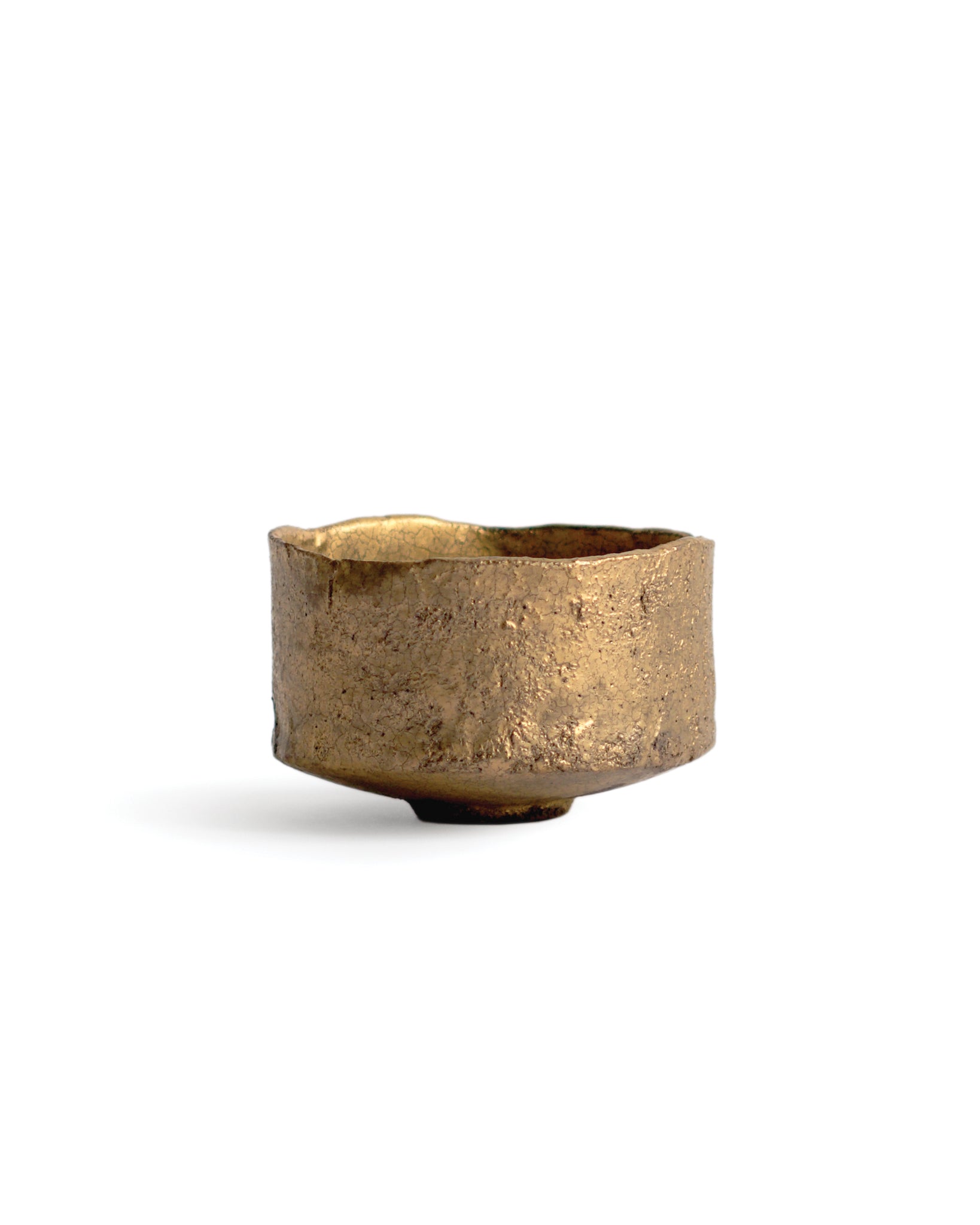 Gold Chawan XIII silhouetted against white background.