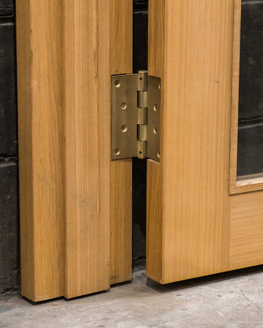 Matureware Brass Flat Hinge Small installed on wooden door, leaf showing open