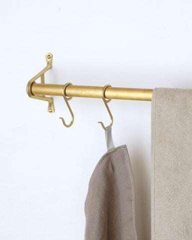 Matureware brass pipe s hooks with linens hanging on them