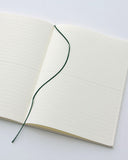 Open midori ruled a5 notebook with a black ribbon bookmark in the center.