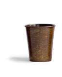 Silhouetted image of the brown urushi wood cup against white background.