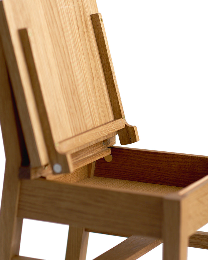 Detailed silhouetted image of the Keepsake Kids Chair with its seat lid open on a white background.