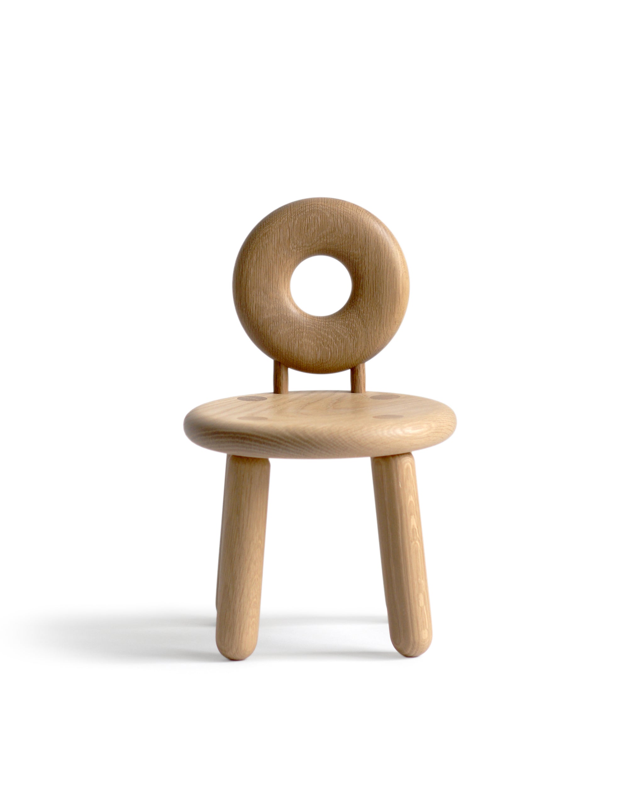 Bialy wood children's chair against white background. Designed by Pat Kim.