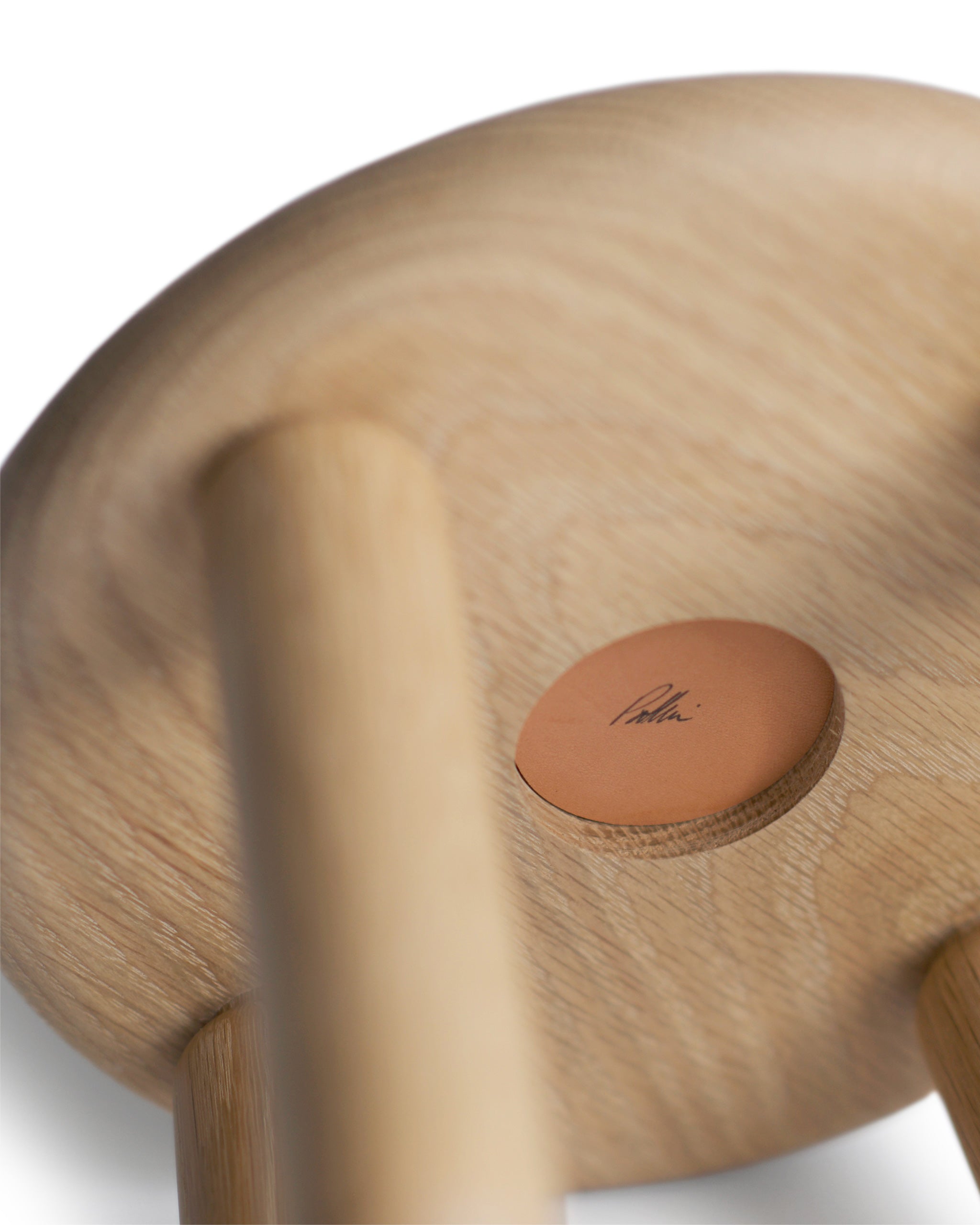 Detailed image showing the bottom of the bialy children's chair. Designer Pat Kim's signature signed on the bottom of the chair.