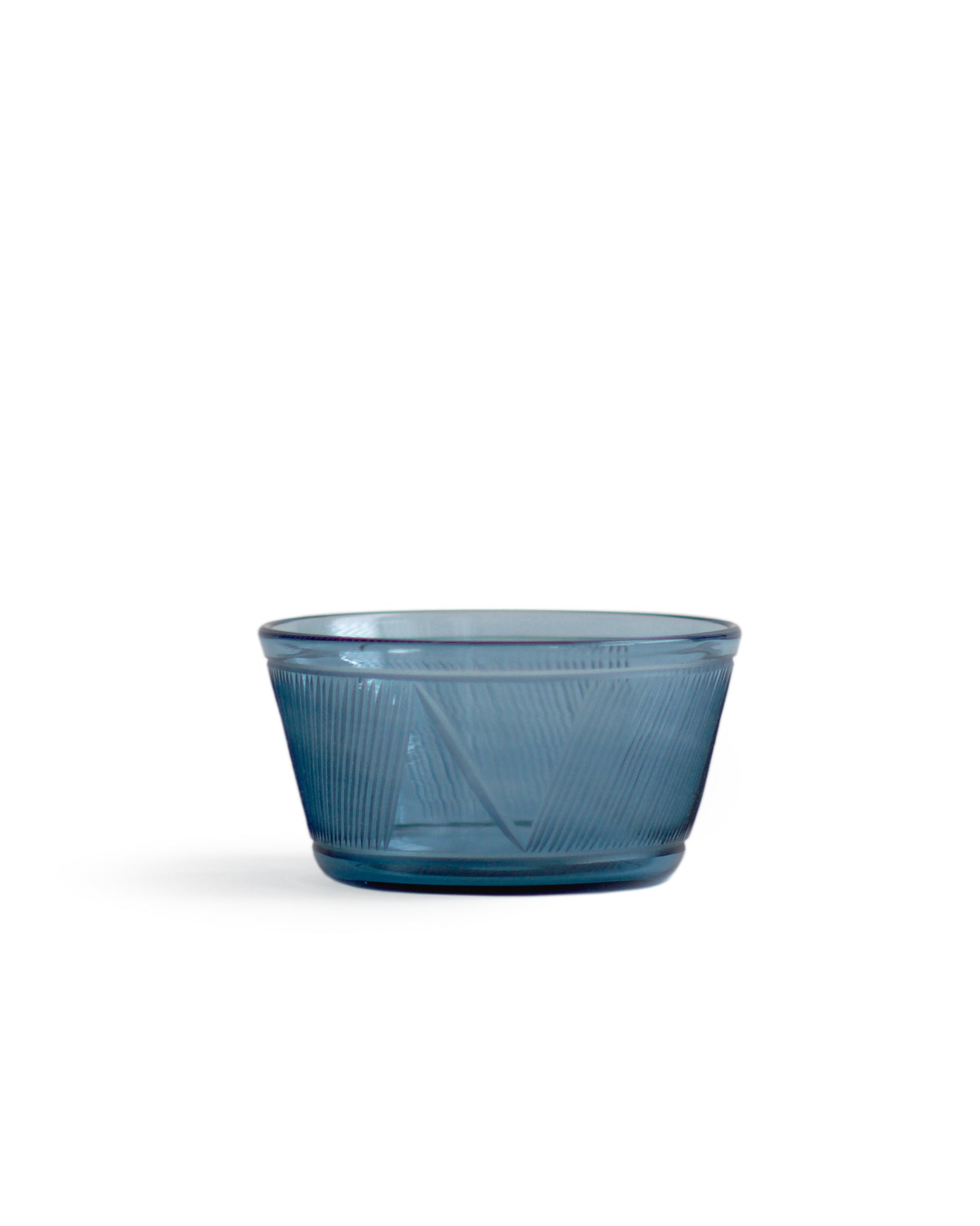 Silhouetted large reclaimed blue bowl in dark blue against white background.