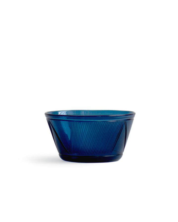 Silhouetted large reclaimed blue bowl in dark blue against white background.