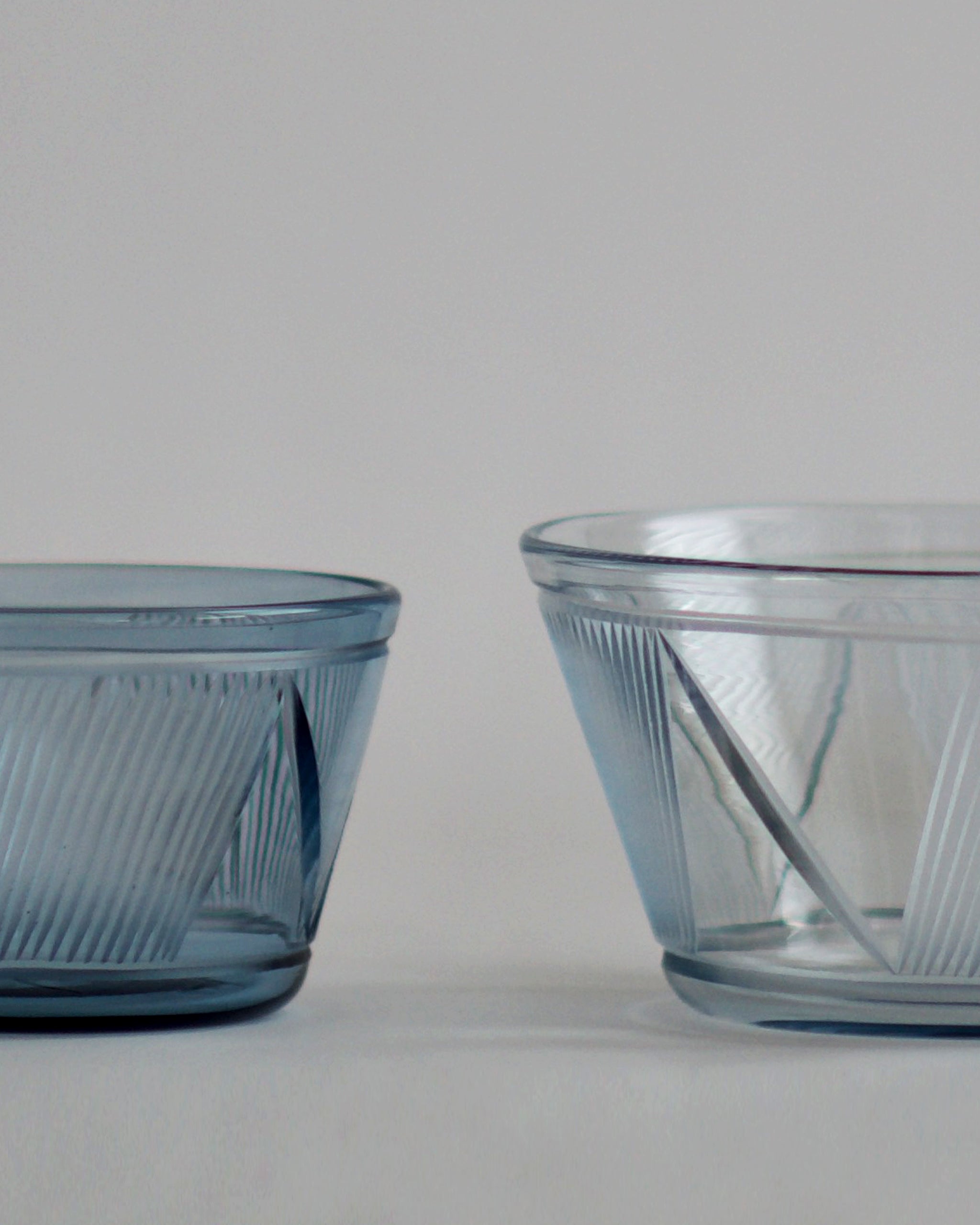 Cropped detail of the small and large reclaimed blue bowl next to each other.  featuring signature 'Factory Zoomer x Nalata Nalata' cut glass pattern. 