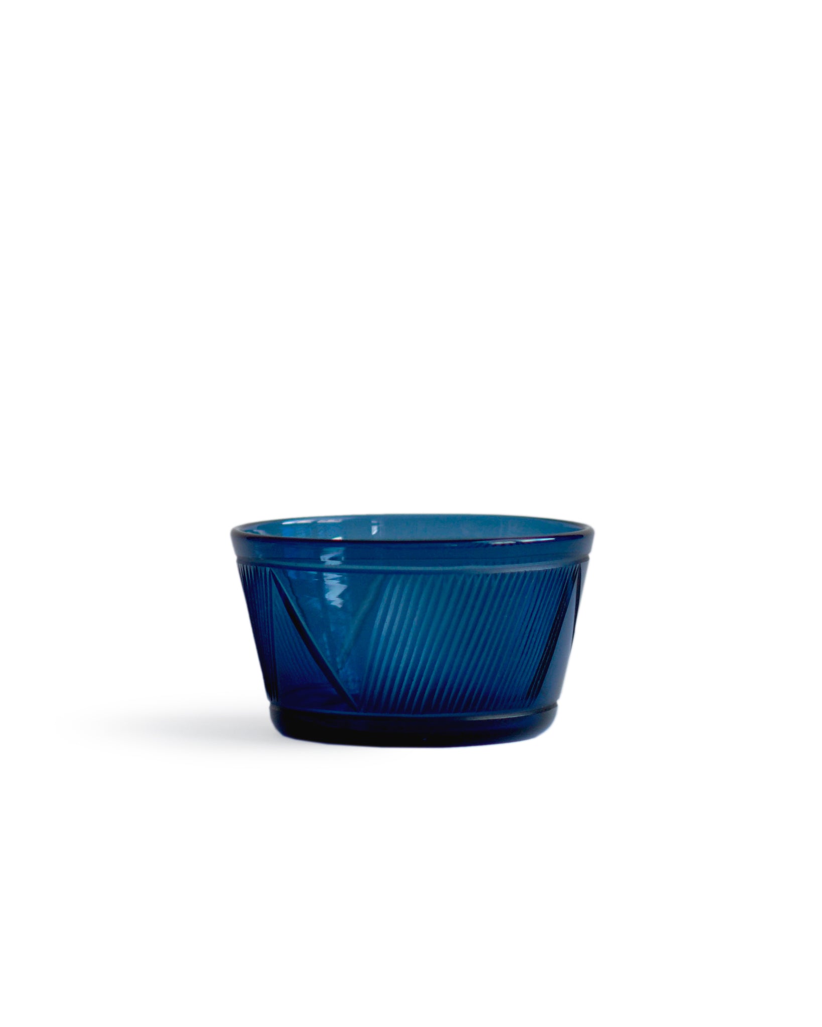 Silhouetted small reclaimed blue square bowl against white background.